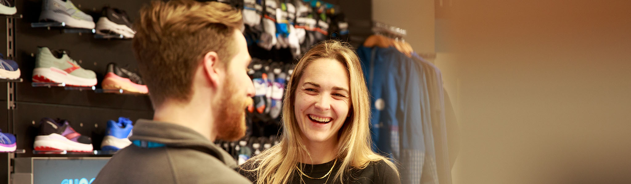 A young woman is talking with a shop assistant