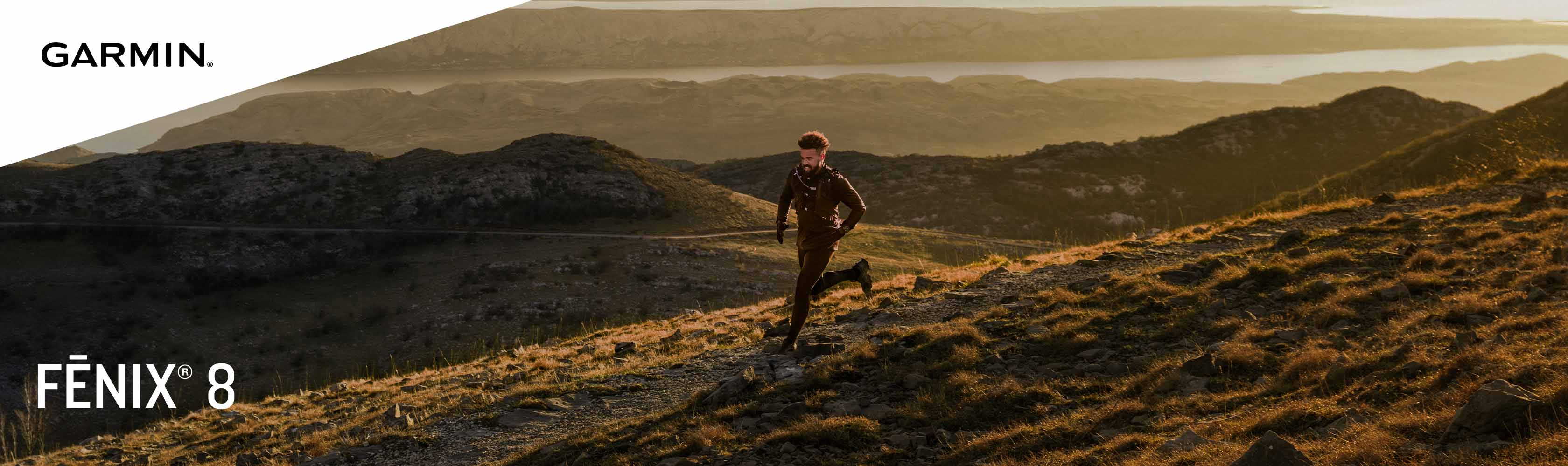 A man running in a field at sunset