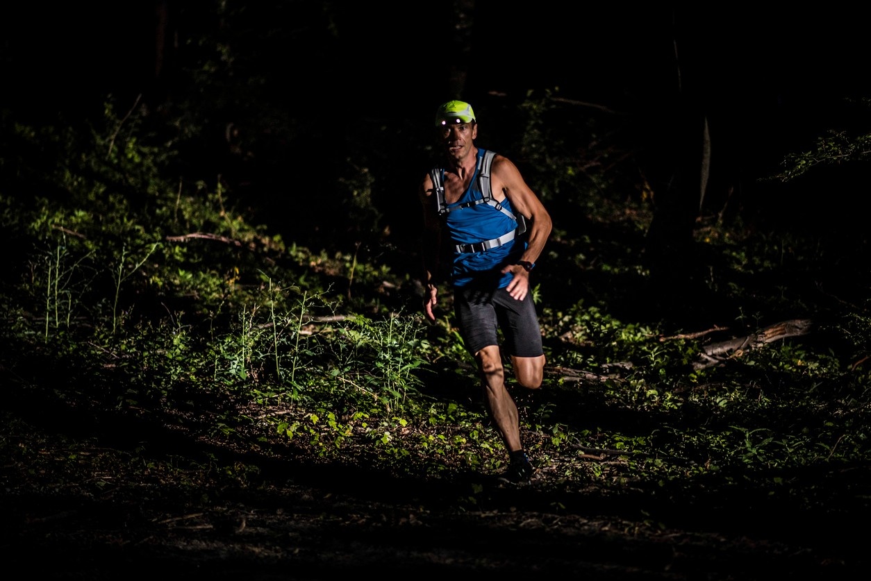 Man running with a running vest at night