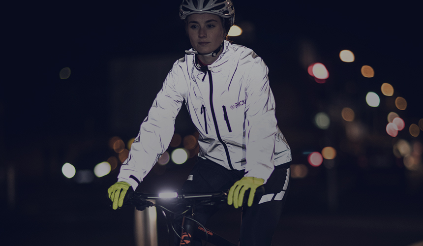 Hi Vis Waterproof jackets. A woman cycling on a bike wearing a hi vis waterproof jacket. 