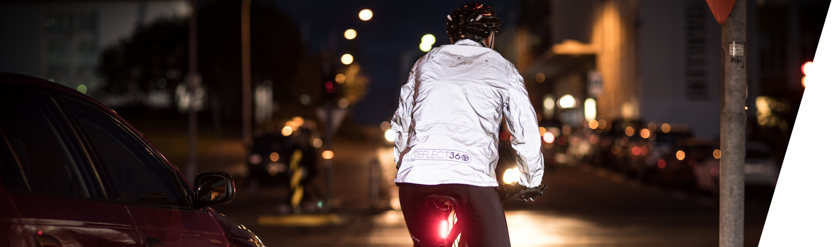 Hi Vis Waterproof jackets. A woman cycling on a bike wearing a hi vis waterproof jacket. 