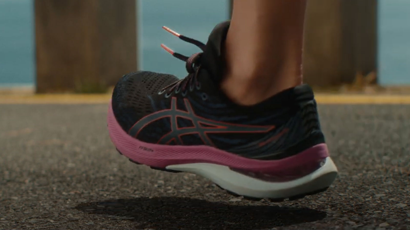 An image of a person wearing Asics running shoes