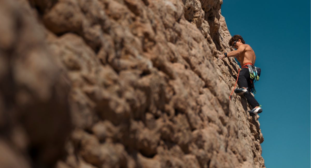 A man climbing a rock formation at the crag