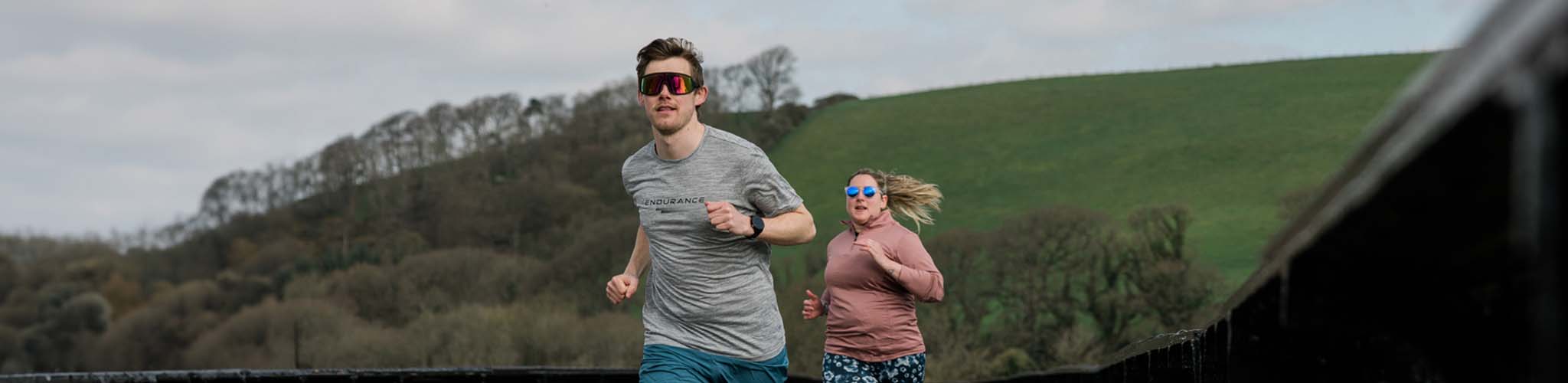 Shop run clothing. A man and woman running 