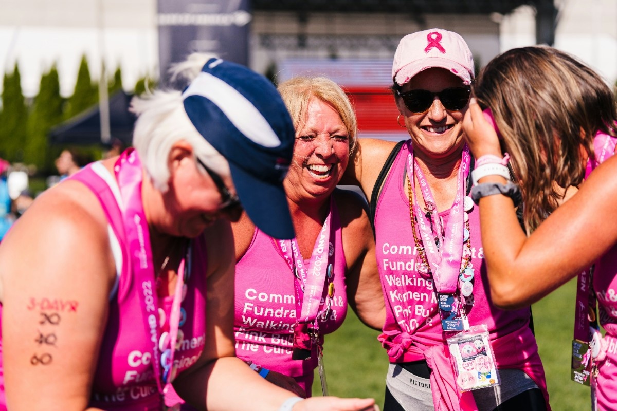 Four women wearing Cancer Research clothing at RFL 