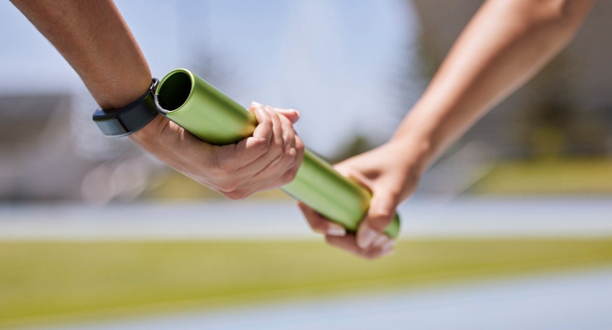 A baton pass in a relay race