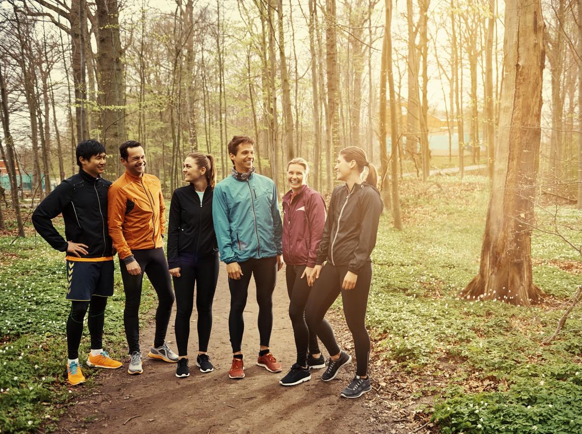 A group of people in the woods in their running gear