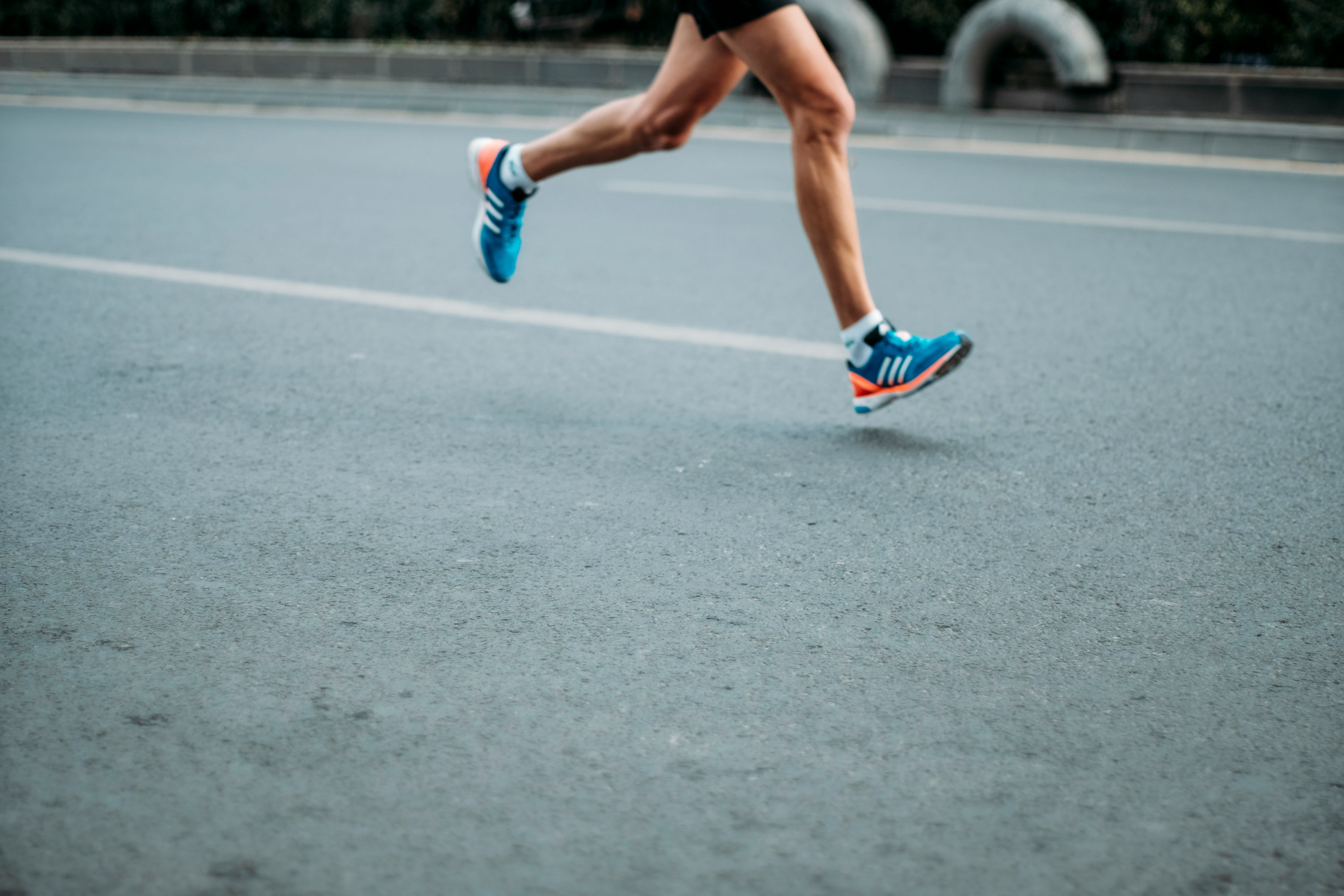 A person running in their Adidas running shoes