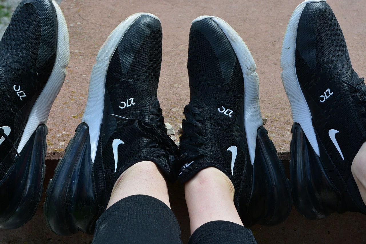 Women's Running Shoes. An image of two people sat next to each other wearing matching Nike shoes