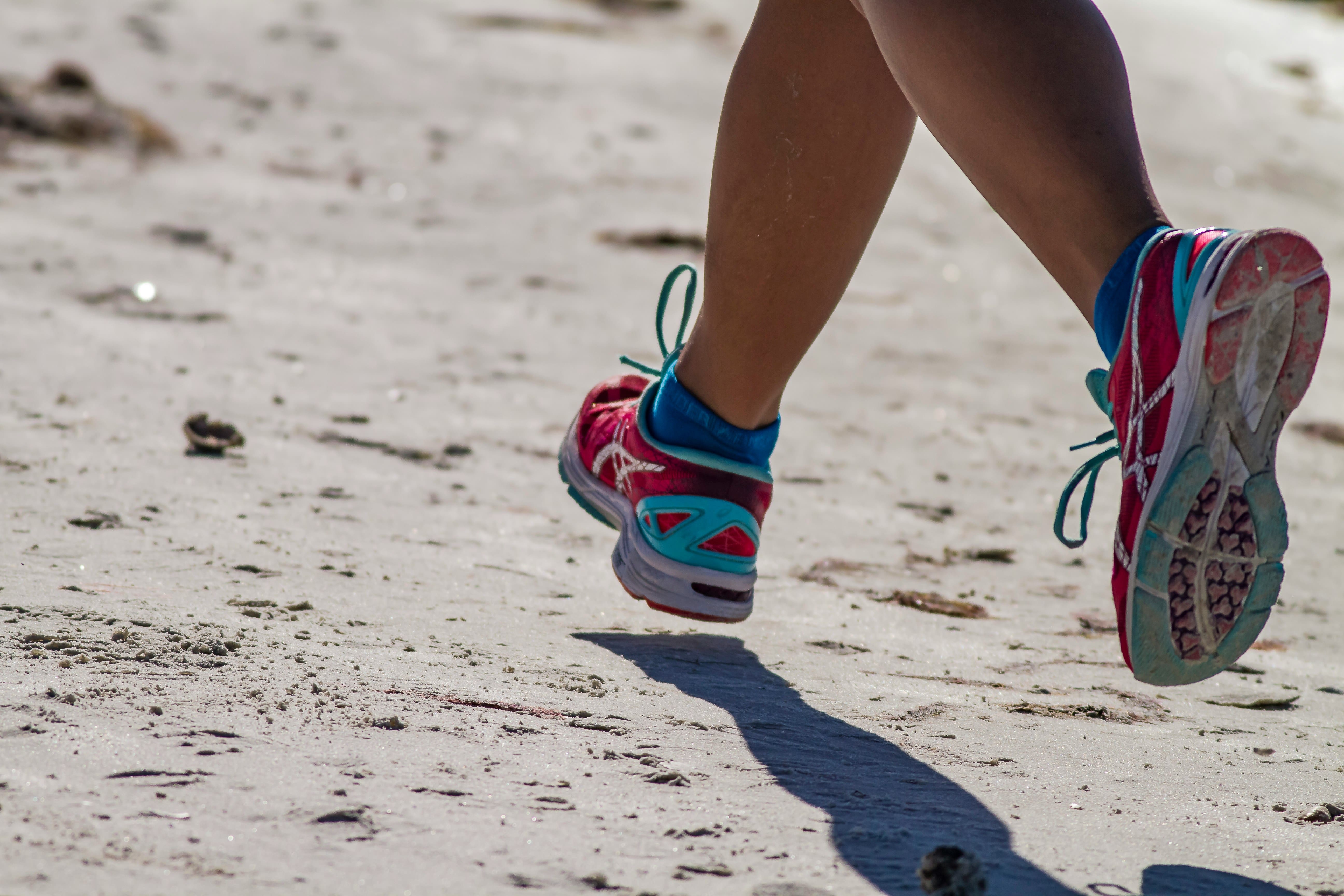 An image of a woman running on a beach 