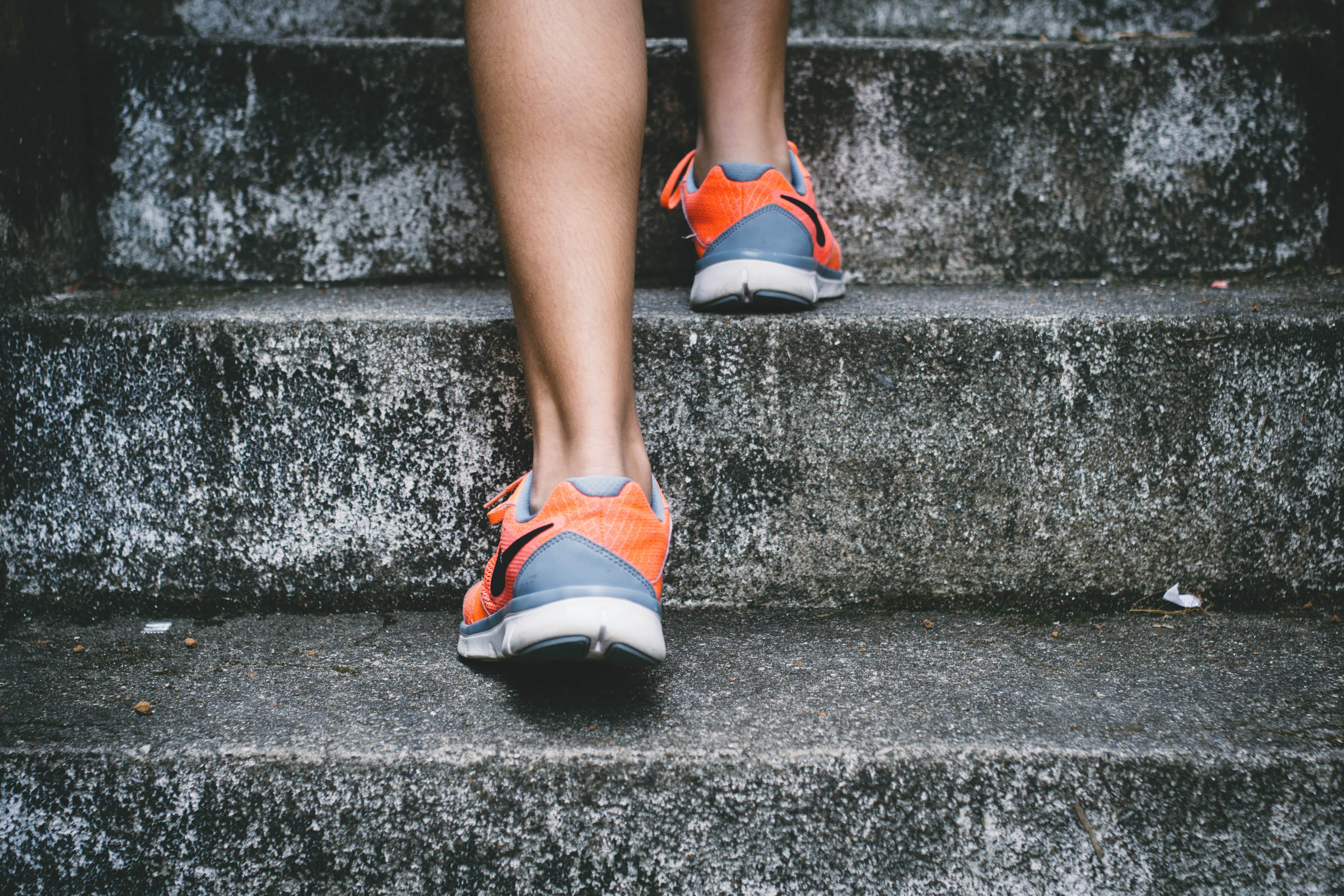 An image of a woman running up some steps in her Nike running shoes