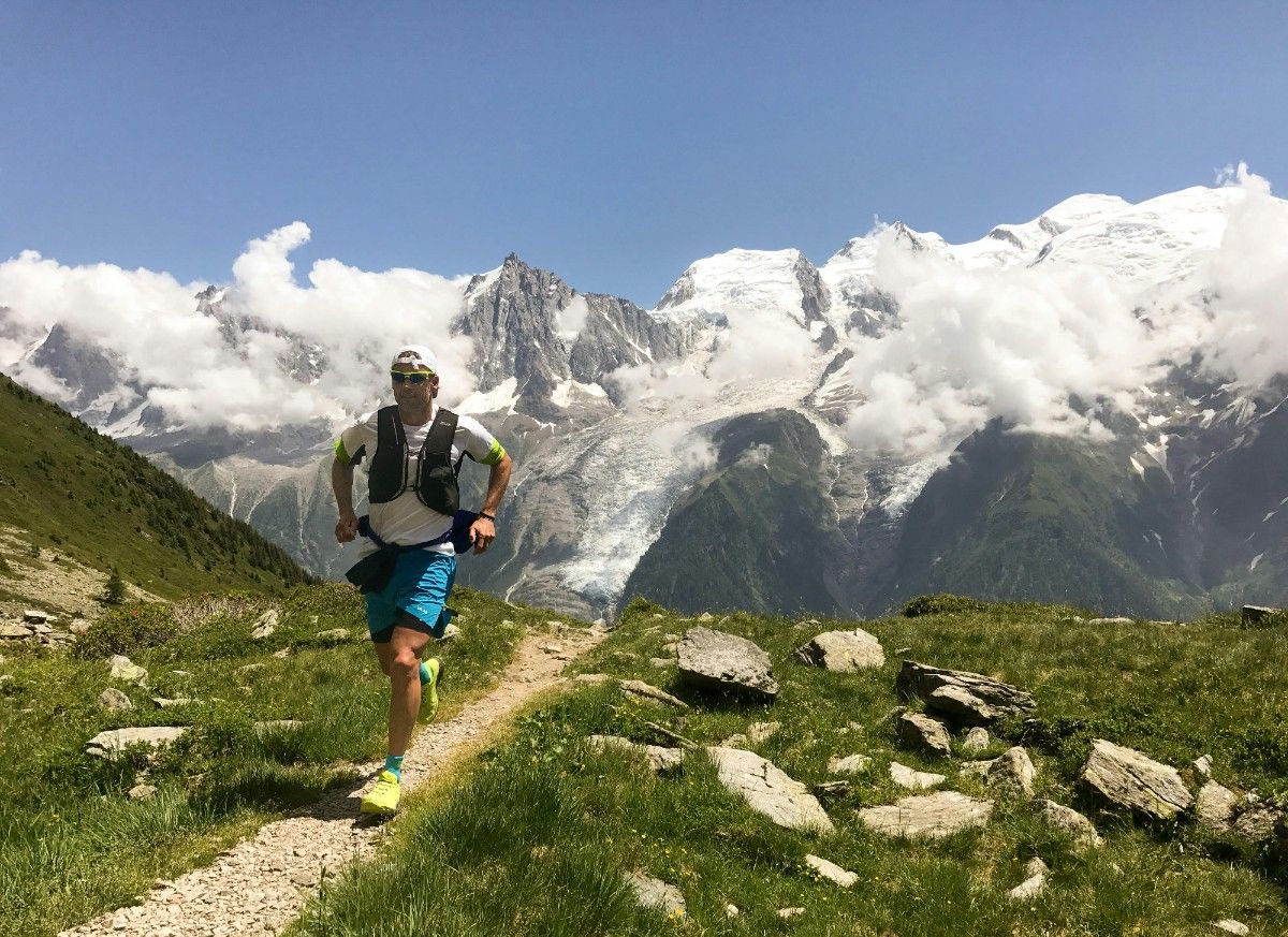 Man running with a black running vest