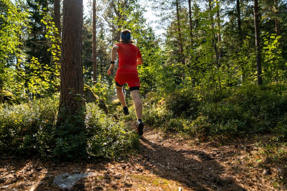 A person trail running through the forest 