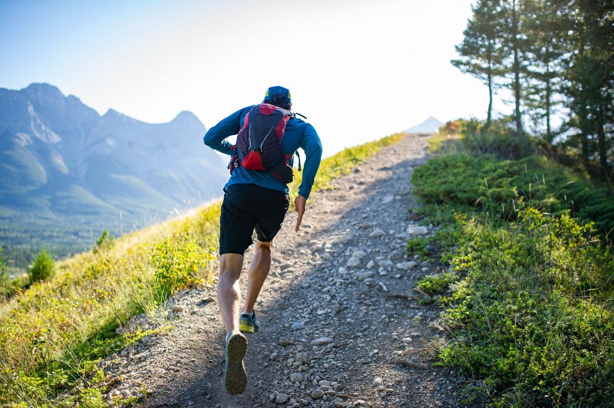 A man running wearing a trail running rucksack