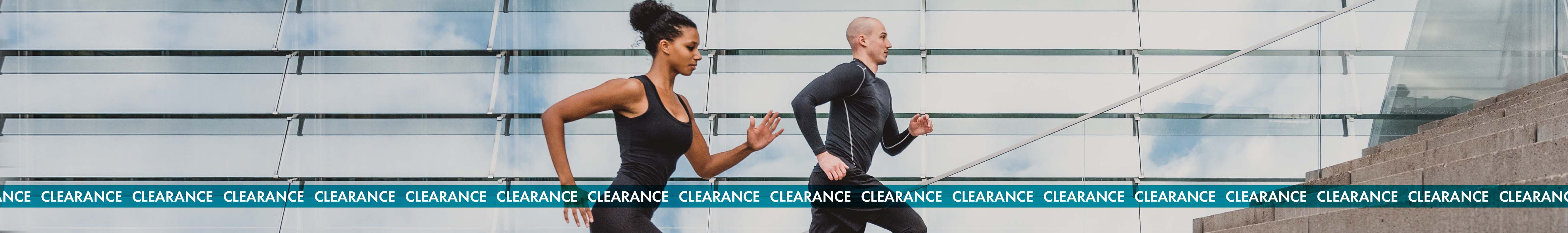 Clearance section. A man and a woman running up the stairs in sports outfit