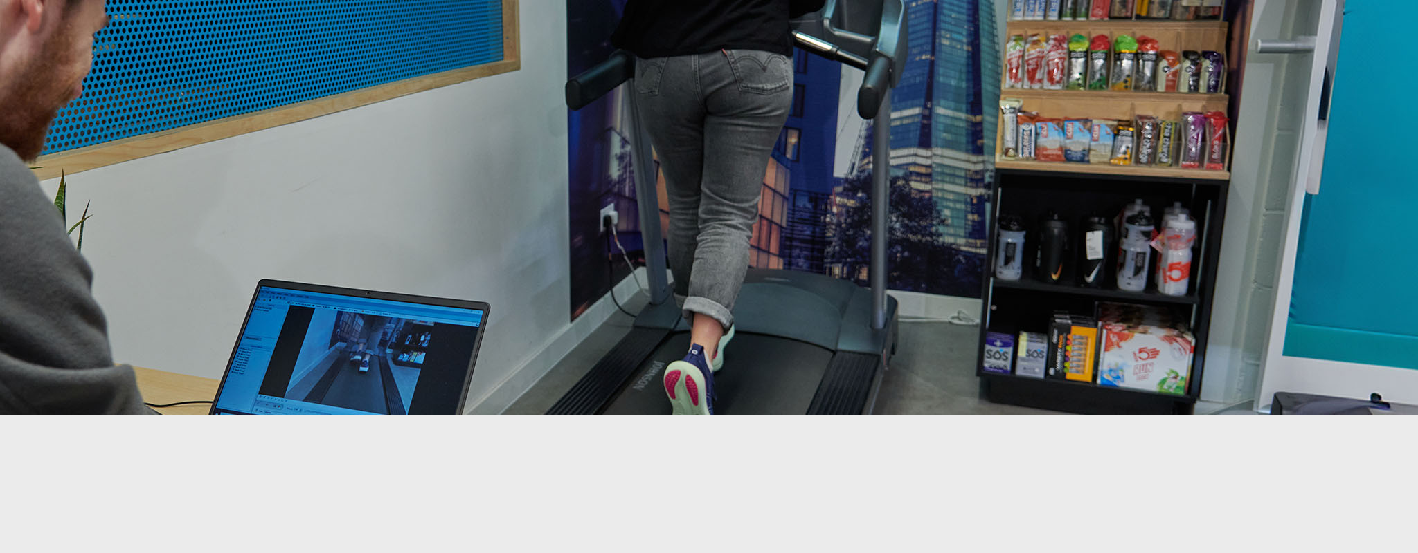 Gait analysis. A person running on a gait analysis machine