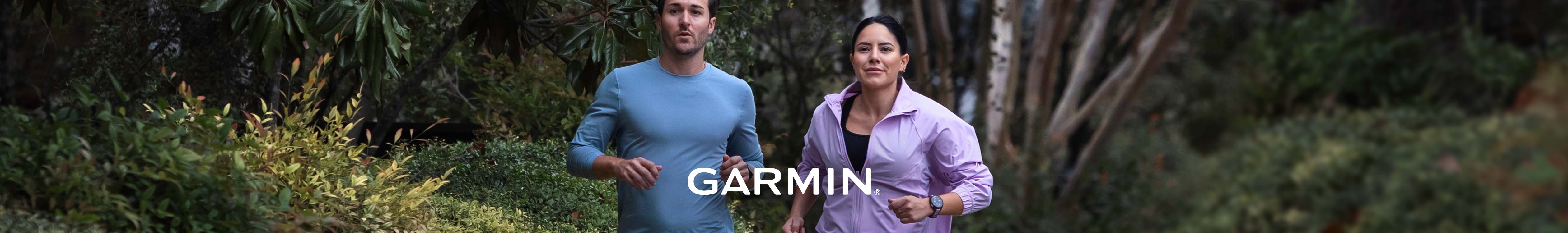 Shop Garmin Forerunner 165. Man and woman running in a forest.