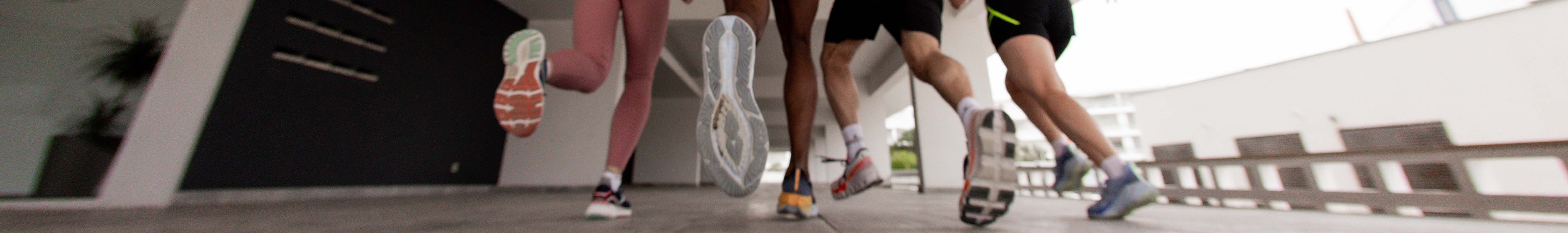 Shop Race & lightweight running shoes. A group of runners racing on a pavement