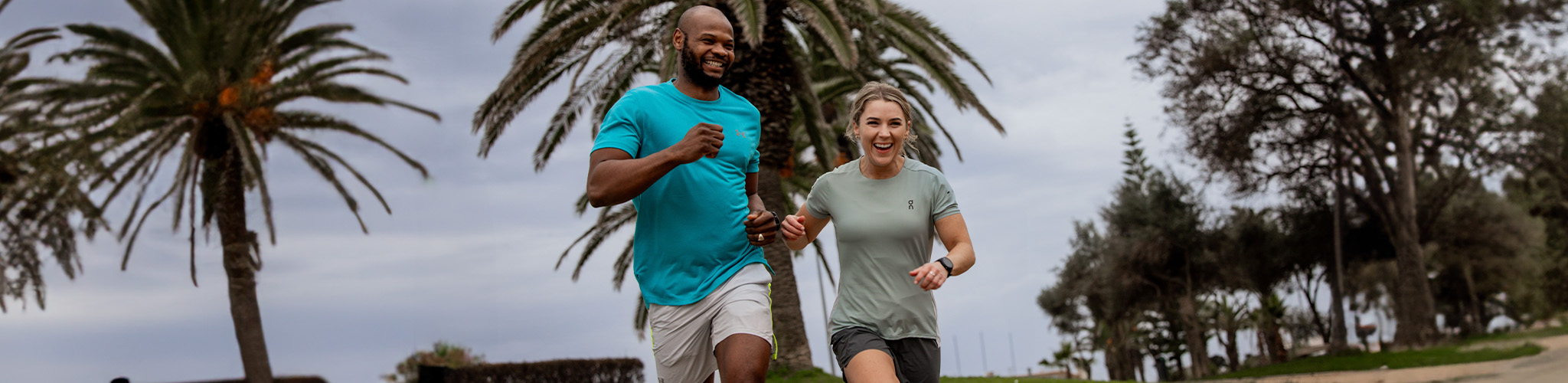 Shop Clothing new season. A man and woman running on the road