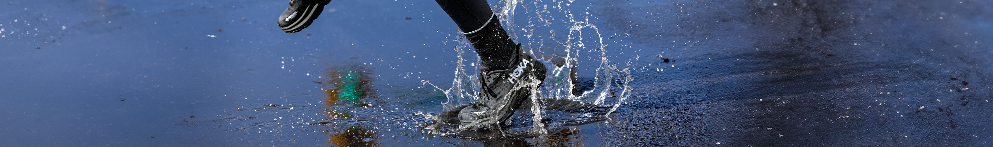 Shop Waterproof shoes. Runner running on a rain-covered road