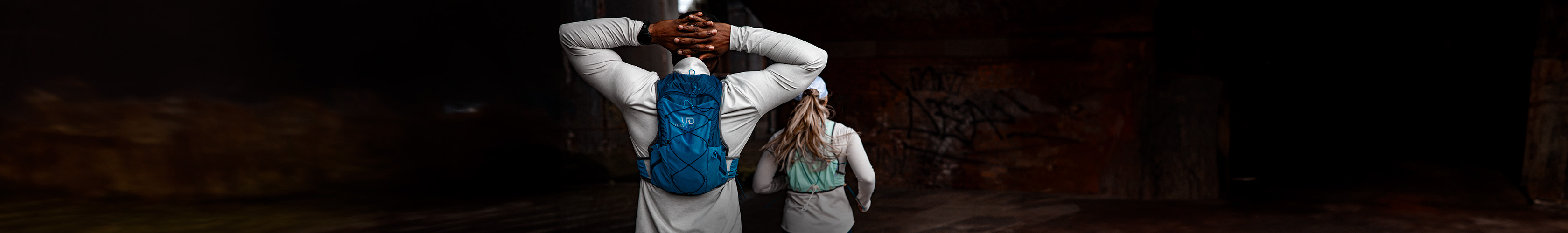 Shop accessories new season. Man and woman running in a street with backpacks