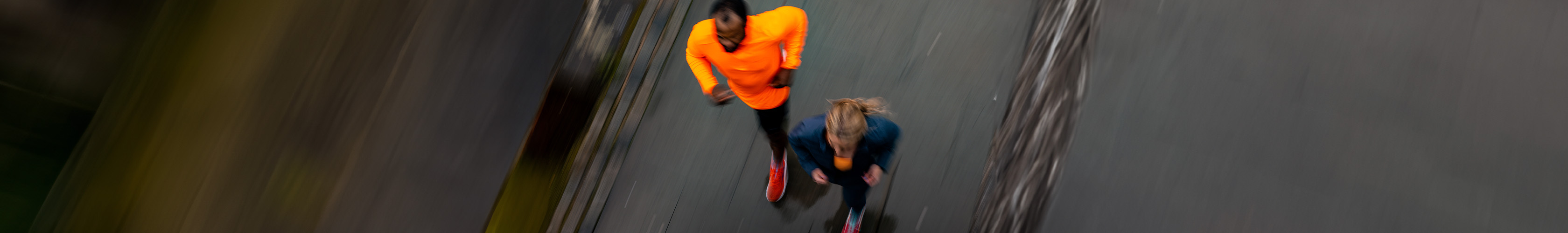 Shop marathon new season. Man and woman running on a road