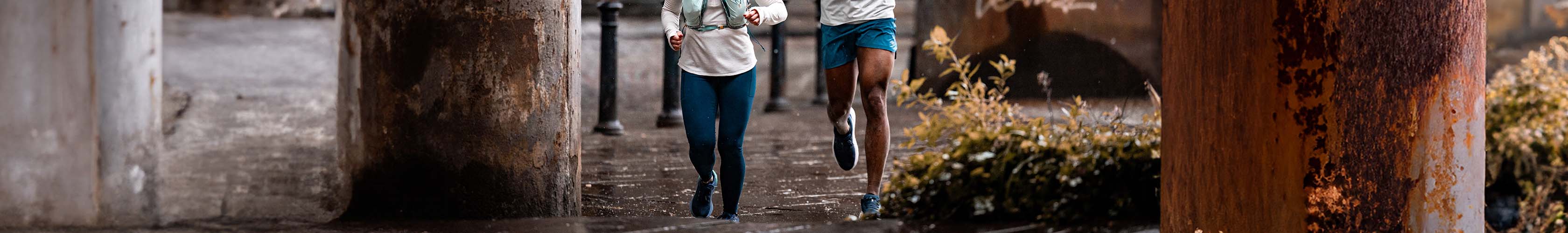 Shop running legwear. Group of runners running along a city street