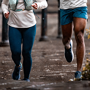 Shop Tights & shortss. A woman in blue tights running on the road