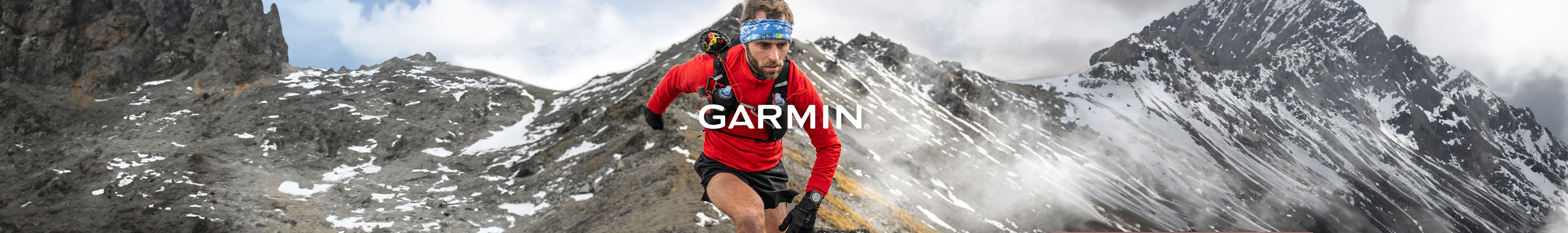 Shop Garmin Enduro 3. A man running on a hill