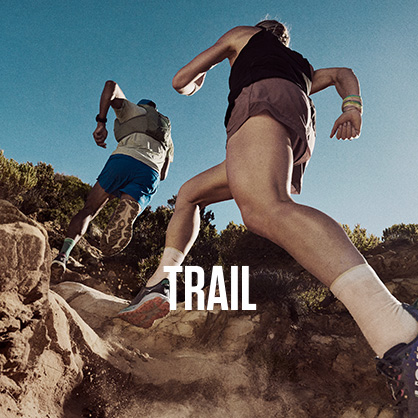 Shop trail running. Two men running on a hill path