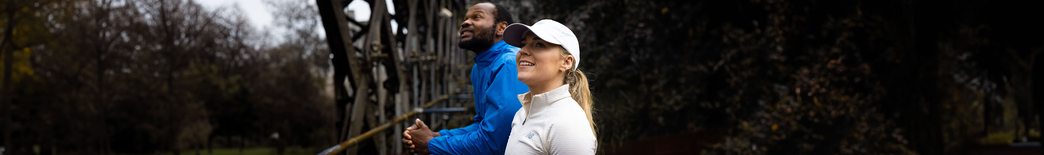 Shop Clothing new season. A man and woman standing in the street