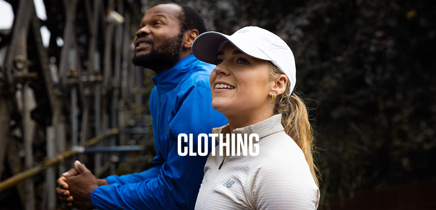 Shop Clothing collection. A man and woman standing in the street