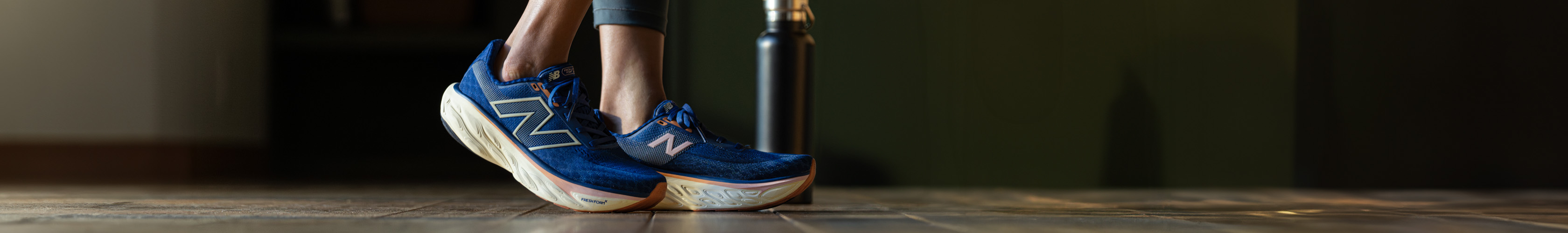 Shop road running shoes. A runner in pair of New Balance shoes preparing for a run