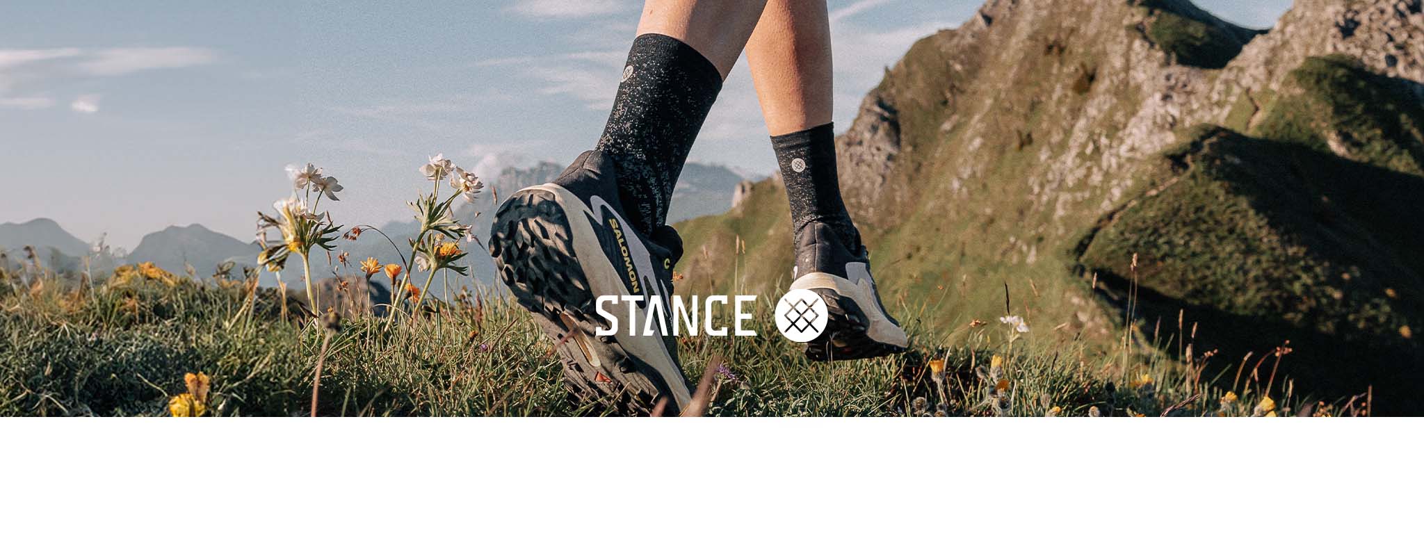 Shop Stance Socks. A pearson walking on a rocky path