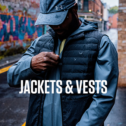 Shop jackets & vests. Man zipping a jacket under blue vest