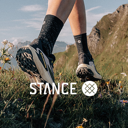 Shop Stance Socks. A pearson walking on a rocky path