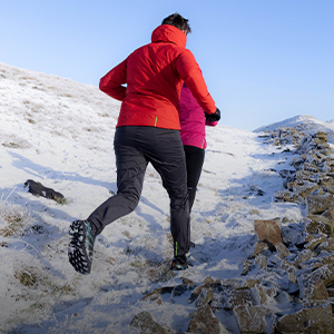 Shop winter gear. Two runners on a snowy path