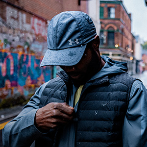 Shop running hats on Runners need. A man wearing blue running hat in an urban setting