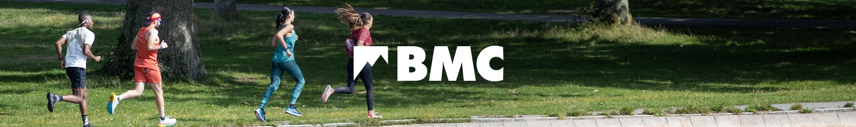 BMC logo. Two men running in field. 